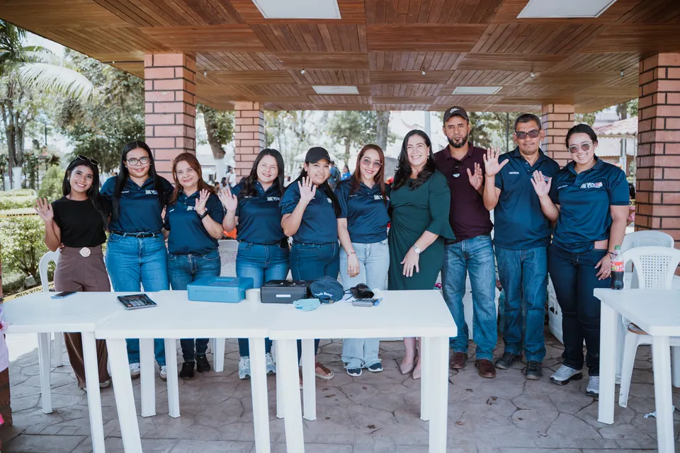 Grupo de personas posa junto a una mesa durante una actividad comunitaria