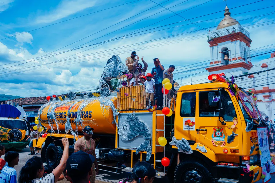 Carroza decorada para una celebración recorre una calle